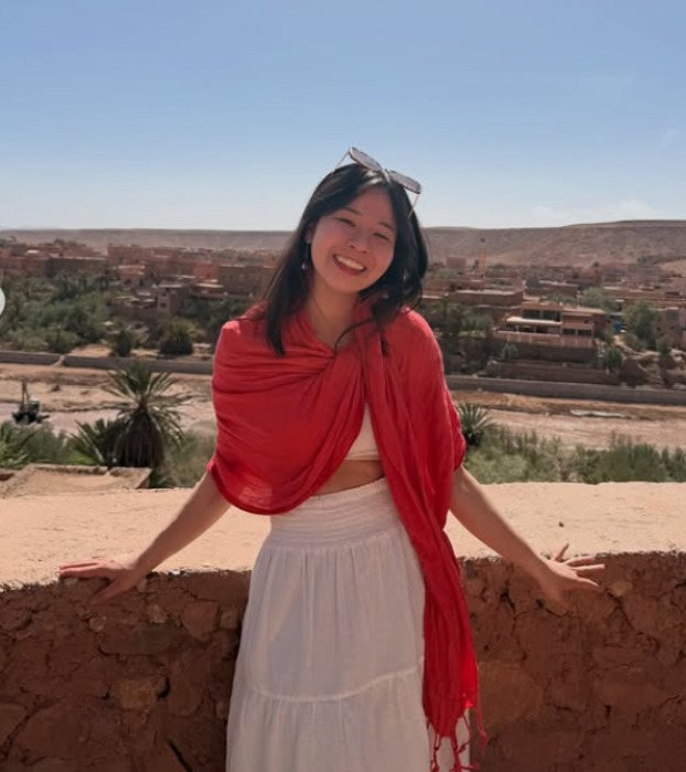 Bianca, a Hoppswap member in Lyon, smiling with a red shawl